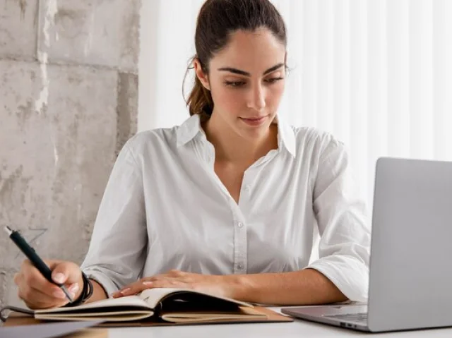 A young student takes notes from a virtual class.